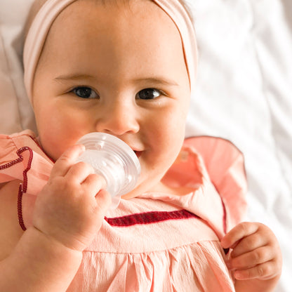 Baby girl with Nippii teething pacifier